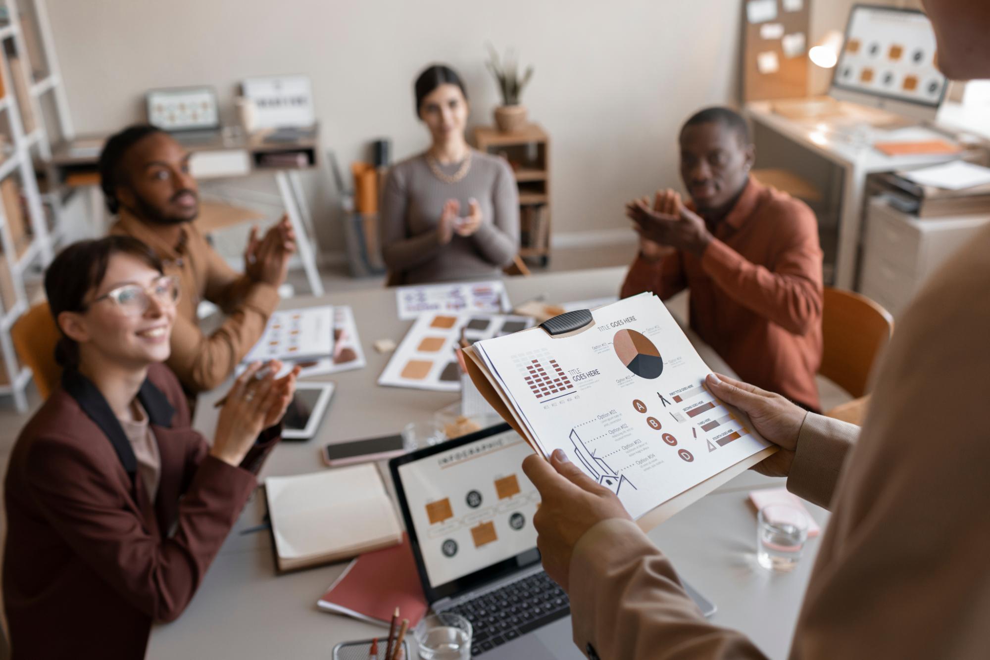 Man showing Takealot advertising stats to group of people